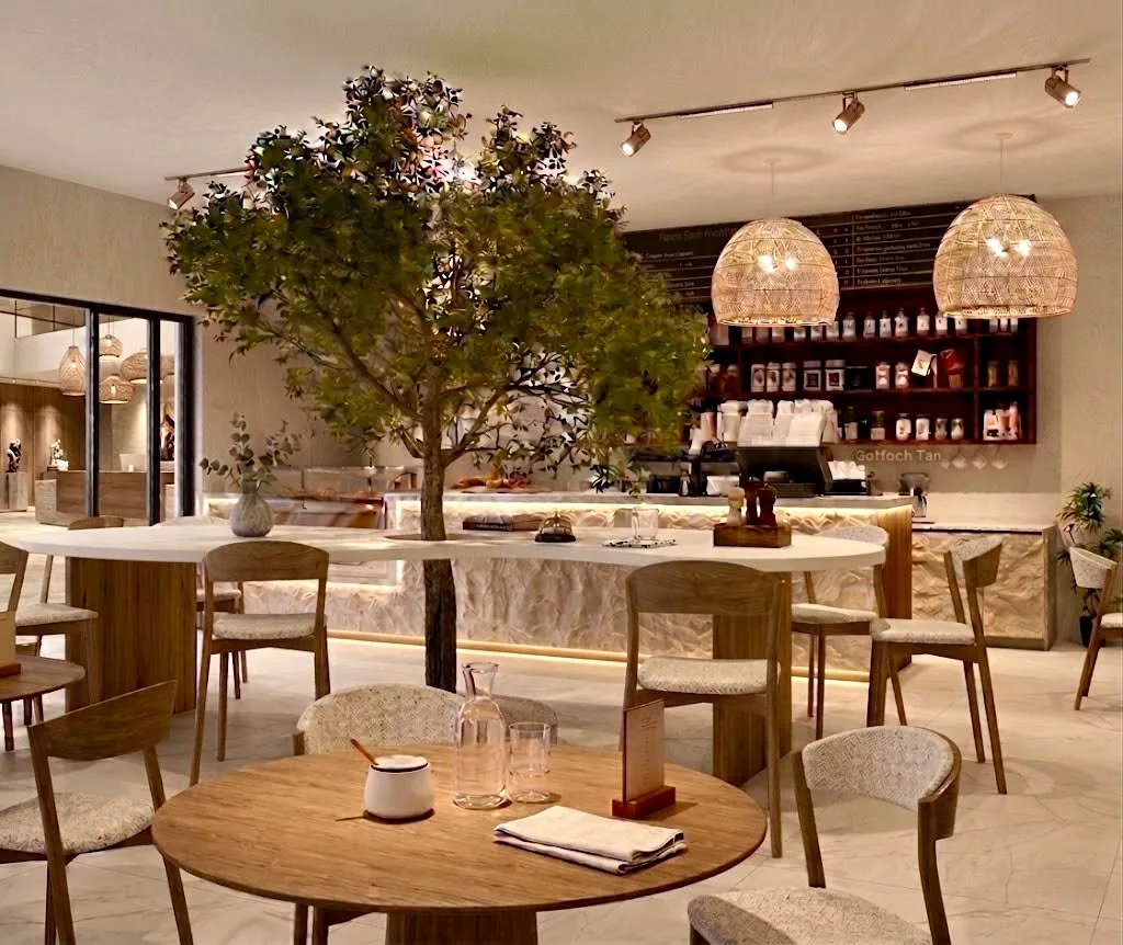 A café floor arranged around an internal tree, with a stone counter and pendant lighting.